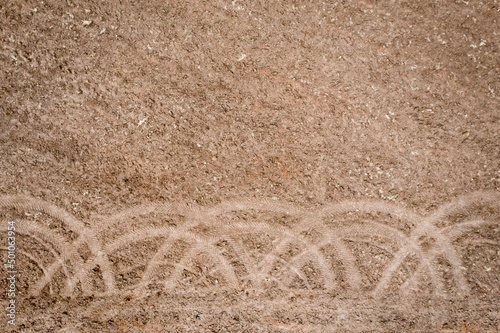 Traces of tractor wheels on a plowed field