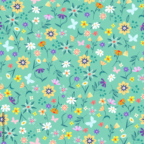 Floral seamless background. Various flowers and leaves on a green background.