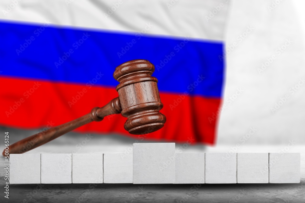 Classic judge's gavel with wooden cubes for the text with Russian flag, Concept on the of sanctions in Russia