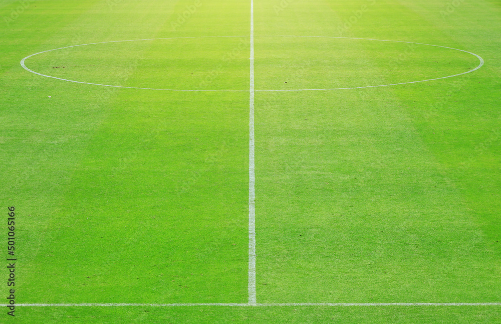 A white line and a circle define the center boundary of a football or