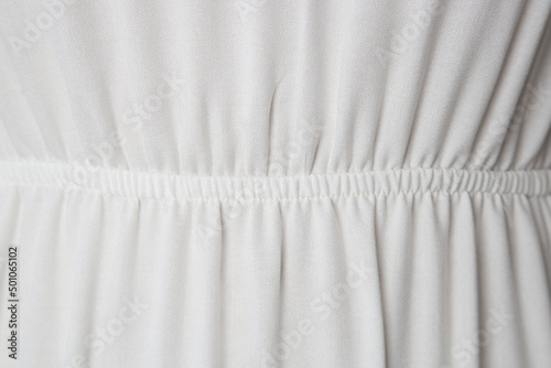 Image of white cotton fabric. Belt with pleated, close up.