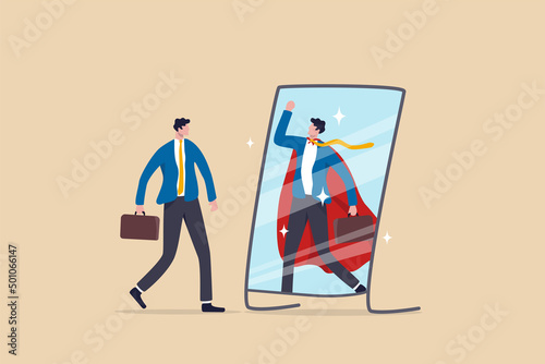 Self confidence or self esteem believe in yourself, positive attitude to success, ambition or determination to achieve goals, businessman looking at his strong ideal self superhero reflection mirror. photo