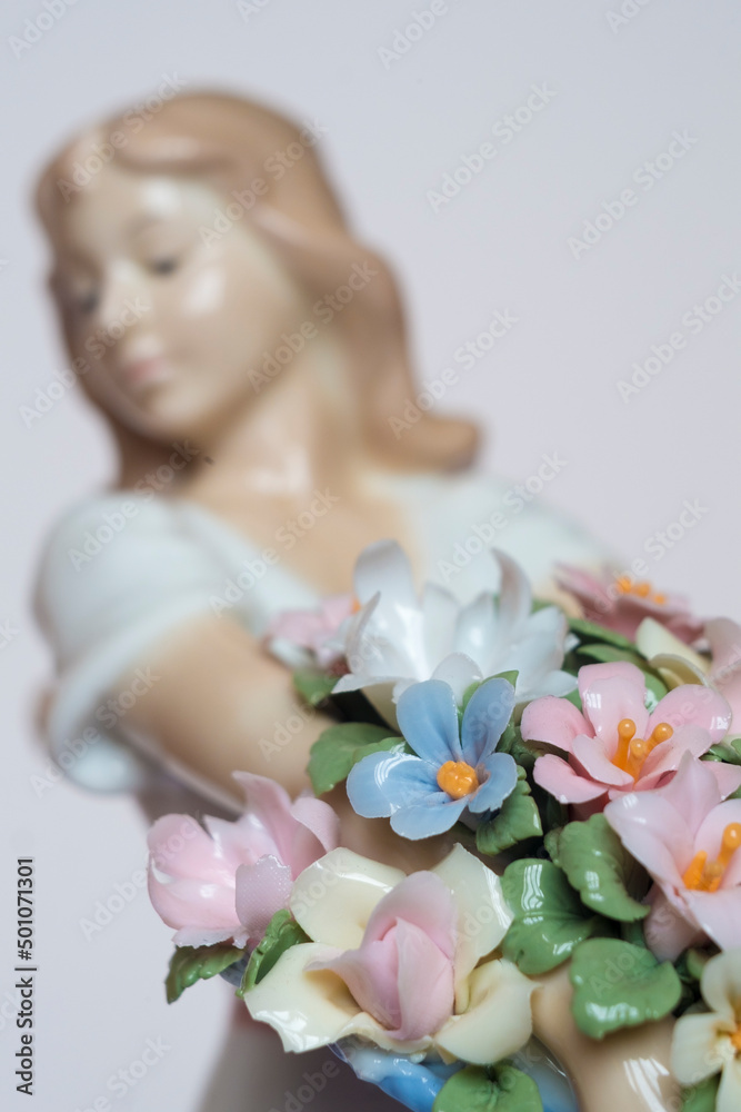 Naklejka premium beautiful porcelain doll with flowers