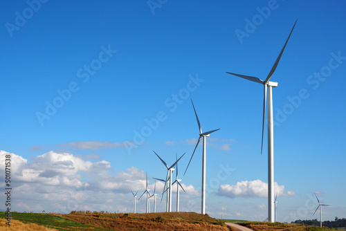 Wind turbine renewable energy source summer landscape with blue sky in natural landscapes © apimook