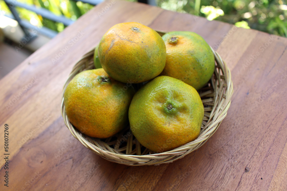 A bowl of oranges and mangosteen A bowl of oranges and mangosteen