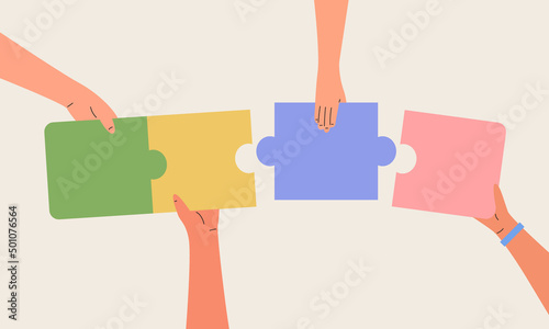 Hand of a group of business people assembling jigsaw puzzle