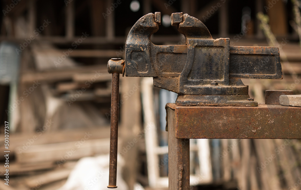 Large work vise Large locksmith vise in the workshop Concept: tool, work, profession Large work vise Large locksmith vise in the workshop Concept: tool, work, profession