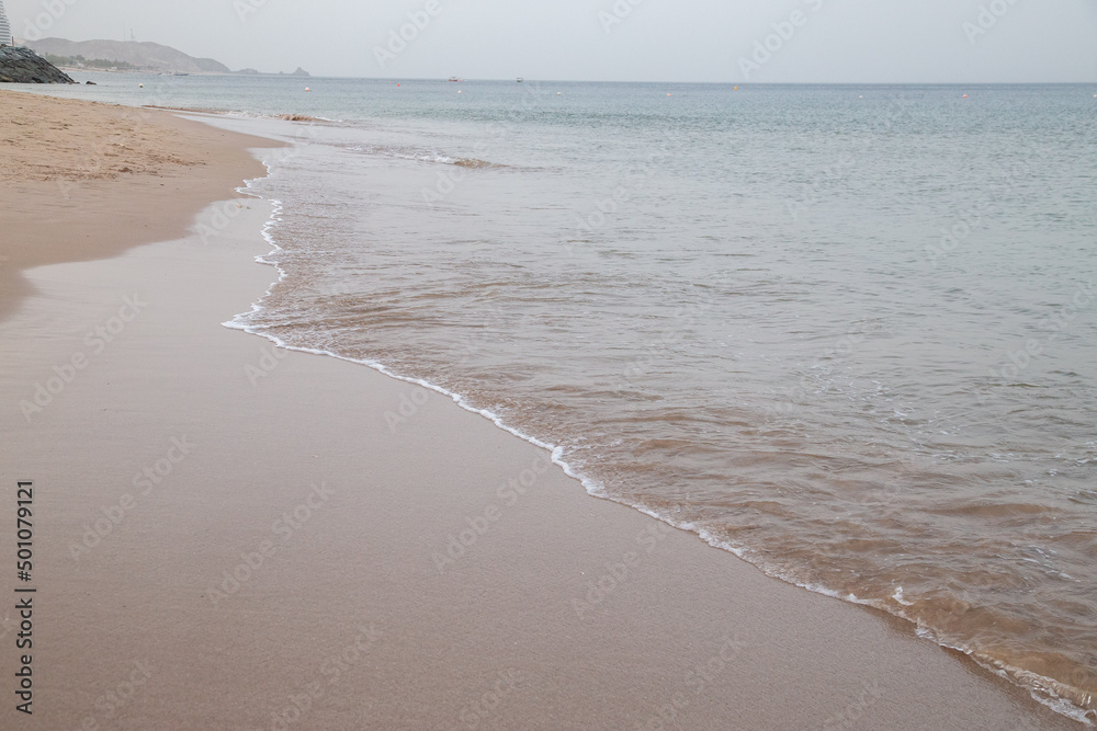 clear beach early morning with surf and sand no people out of focus with grain clear beach early morning with surf and sand no people out of focus with grain