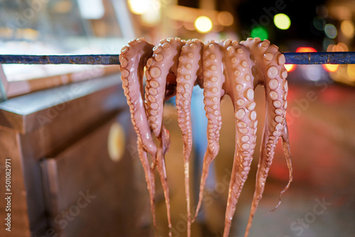 Fototapeta Naklejka Na Ścianę i Meble -  Octopus tentacles dried in a Greek tavern on the street in Greece.