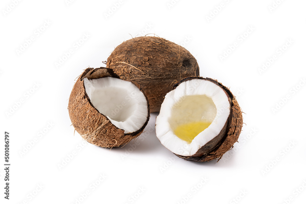 sliced coconuts with oil inside isolated on white background sliced coconuts with oil inside isolated on white background