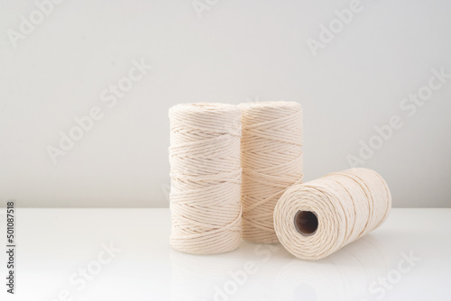 macrame threads wound bobbins of natural beige color