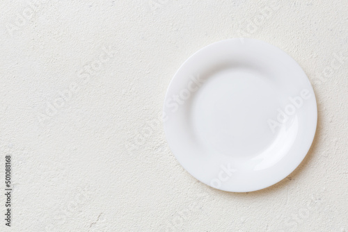 Top view of empty light plate on cement background. Empty space for your design