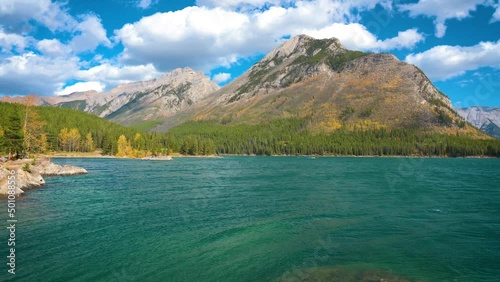 Pan right of Lake Minnewanka with a speedboat in Banff National Park, Canada photo