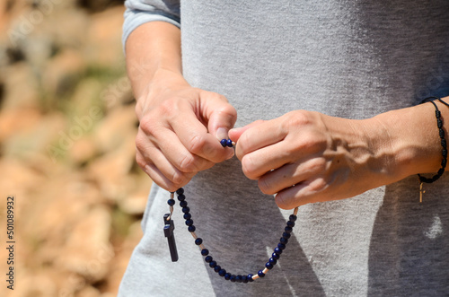 Fotografering Hands of pilgrim holding the rosary