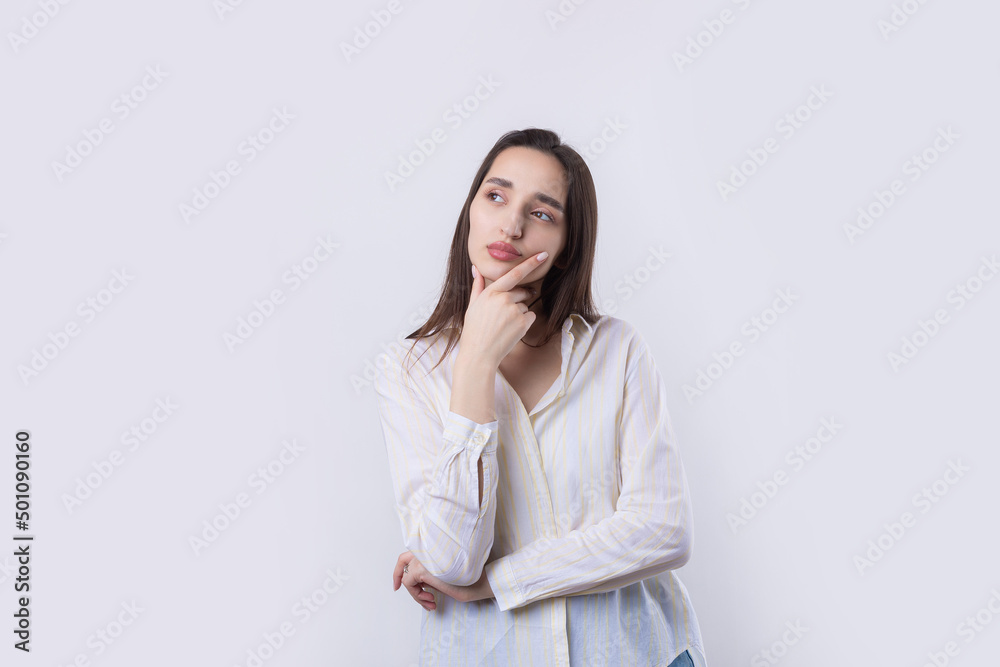 Portrait of a beautiful young woman thinking, isolated on white background Portrait of a beautiful young woman thinking, isolated on white background
