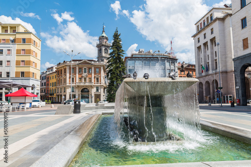 Varese city, Italy. Square Monte Grappa and historic center with fountain and the bell tower (called del Bernascone - 17th and 18th centuries) located beside the basilica of San Vittore photo