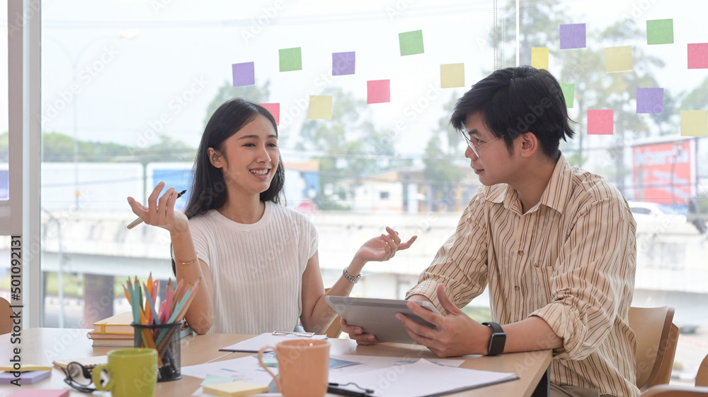 Confident young businesswoman explaining new online project to her colleague. Confident young businesswoman explaining new online project to her colleague.