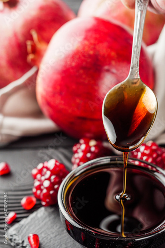 fresh pomegranate sauce narsharab on a black wooden rustic background photo