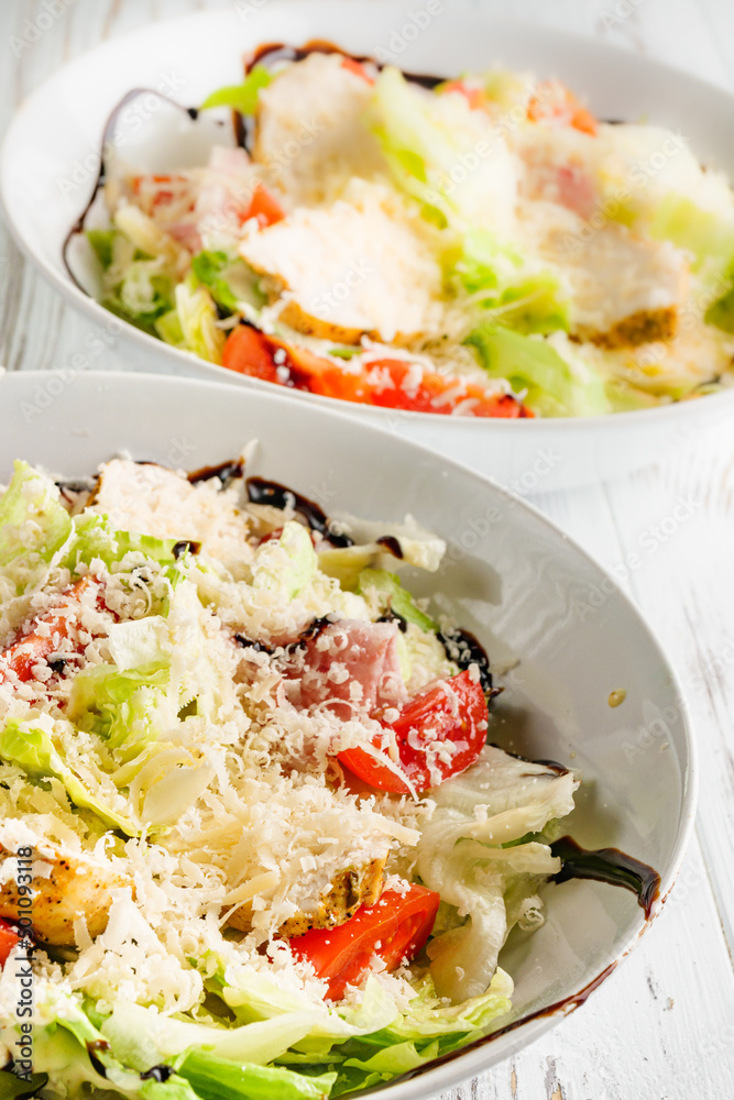 Caesar salad on a white wooden rustic background Caesar salad on a white wooden rustic background