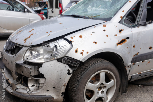 Many shot and destroyed cars of civilians at the car graveyard in Irpin, Ukraine. War in Ukraine. Car accident.