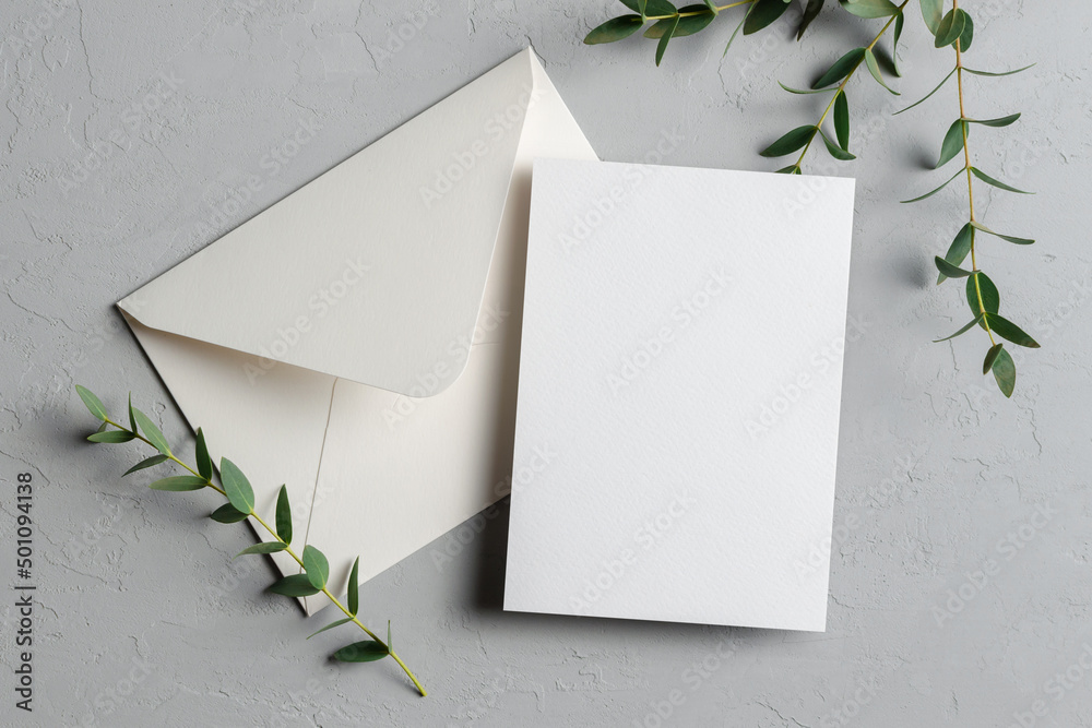 Wedding invitation card mockup with eucalyptus twigs and envelope - obrazy, fototapety, plakaty 