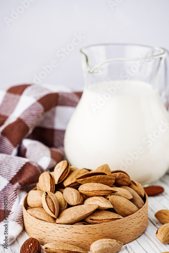 almond milk on a white wooden rustic background