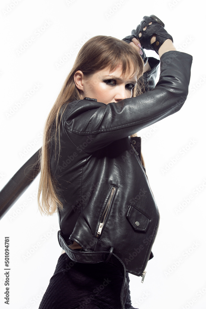 Sportive Caucasian Female Baseball Player Athlete Posing With Bat While Making Swing Wearing Black Leather Jacket Against Pure White Background. Sportive Caucasian Female Baseball Player Athlete Posing With Bat While Making Swing Wearing Black Leather Jacket Against Pure White Background.
