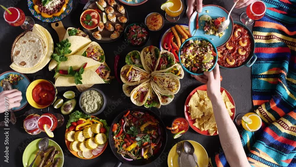 An authentic Mexican family celebrates Cinco de mayo together at a festive table. Mexican food