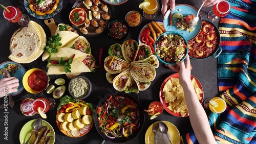 An authentic Mexican family celebrates Cinco de mayo together at a festive table. Mexican food