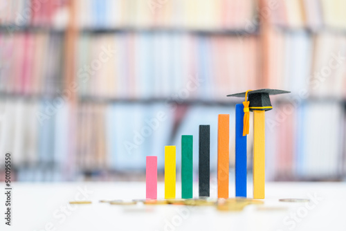 Graduate study abroad program for higher degree knowledge, education concept : Black graduation cap on increasing bar graph, depicting strong effort for students who study hard for a future career.