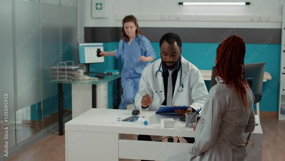 Male obstetrician giving prescription pills in bottle to future mother with baby bump, meeting in medical cabinet. Young doctor helping expectant woman with maternity and childbirth advice. Male obstetrician giving prescription pills in bottle to future mother with baby bump, meeting in medical cabinet. Young doctor helping expectant woman with maternity and childbirth advice.