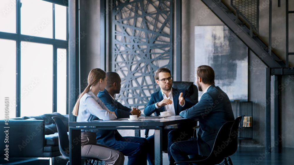 Corporate manager communicating with a business team in a loft