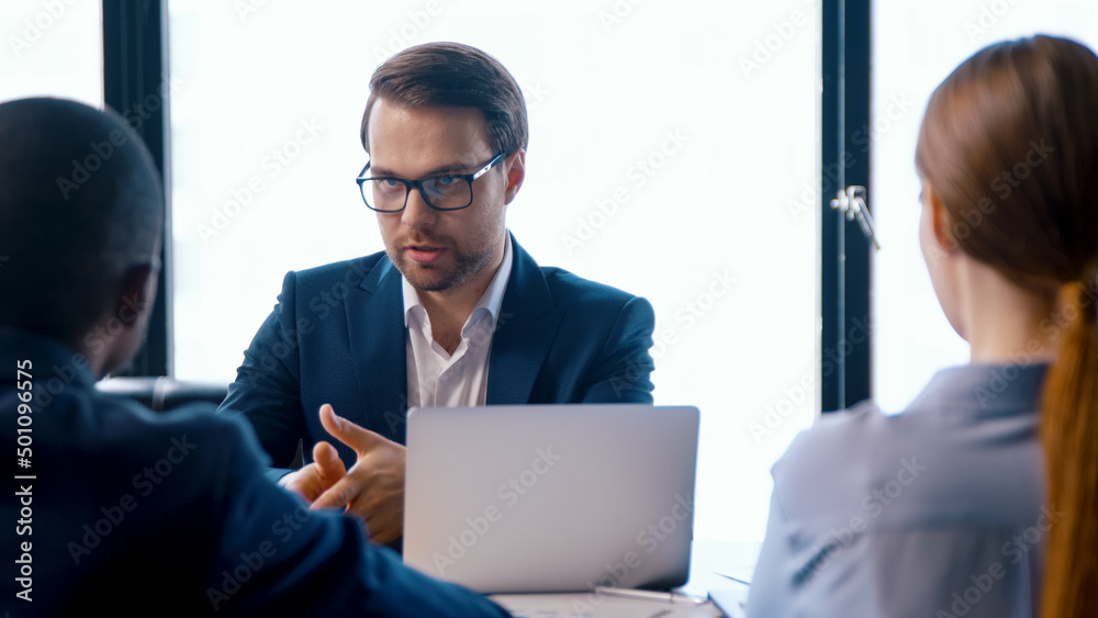 © AboutLife - Young director giving new ideas about the project to his business partners