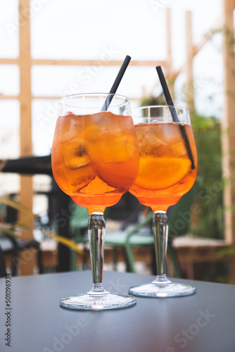 Fotografiet Two glasses of Aperol Spritz served on the terrace of modern bar