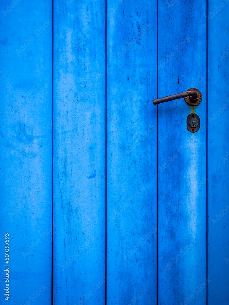 Obraz premium Blue painted door closeup with simple handle, plenty of space for text or logo