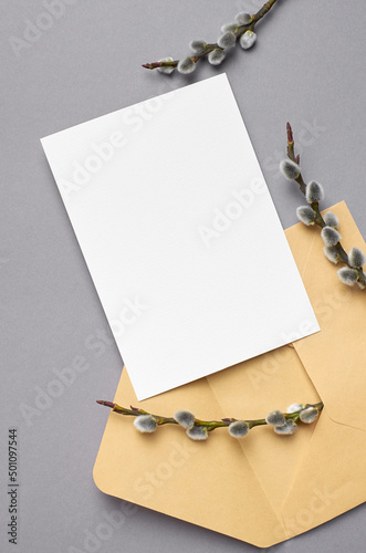 Invitation or greeting card mockup with envelope and willow twigs