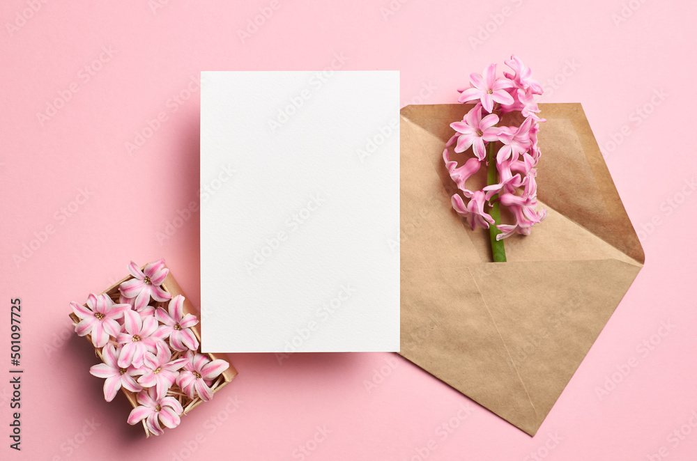 Invitation or greeting card mockup with envelope and spring hyacinth flowers on pink background Invitation or greeting card mockup with envelope and spring hyacinth flowers on pink background