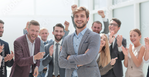 close up. cheerful company employees applauding their colleague.