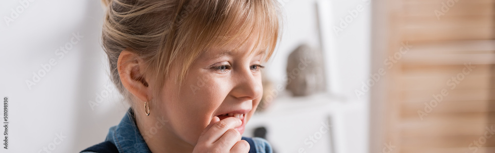 Girl touching mouth during speech therapy in classroom, banner. Girl touching mouth during speech therapy in classroom, banner.