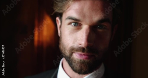 Young bearded man looks at the camera, preparing for wedding