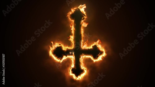 Exciting and highly emotive reveal animation of an ornate inverted satanic Crucifix cross, in roaring flames, burning embers and sparks, on a smokey, glowing black background photo