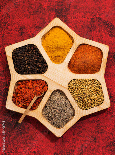 Spices, herbs, spicy and seasoning in a wooden box top view.