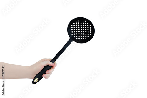 Black spoon skimmer for cooking in hand of  caucasian woman. White isolate.
