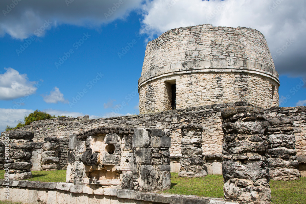 Chac Mask in the foreground, Round Temple in the background, Mayan Ruins, Mayapan Archaeological Zone, Yucatan State, Mexico Chac Mask in the foreground, Round Temple in the background, Mayan Ruins, Mayapan Archaeological Zone, Yucatan State, Mexico