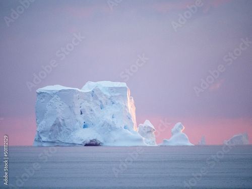 Sunset on a large iceberg at sea towards Peter I Island, Bellingshausen Sea photo