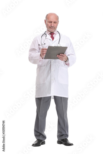 Front view of mature serious doctor writing on clipboard