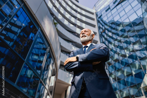 Fotografija Low angle view of a proud senior businessman standing at the business center