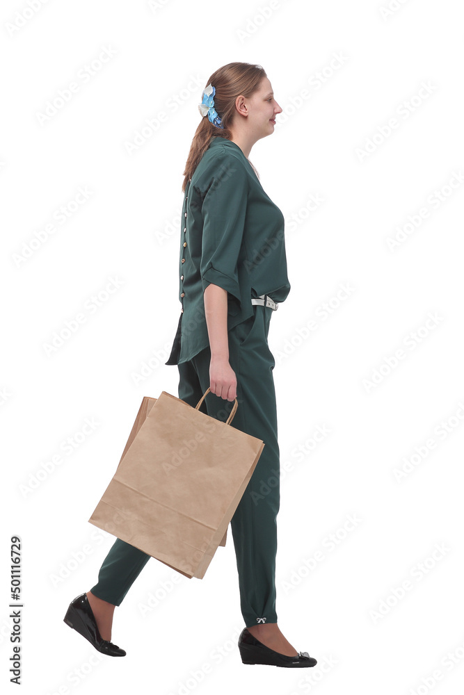 Full length side view of happy young woman walking with shopping bags Full length side view of happy young woman walking with shopping bags