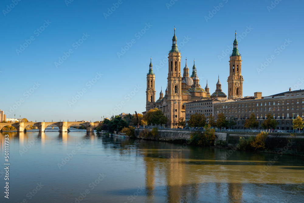 Basilica del Pilar Cathedral with stone bridge crossing Ebro River, Zaragoza, Aragon Basilica del Pilar Cathedral with stone bridge crossing Ebro River, Zaragoza, Aragon