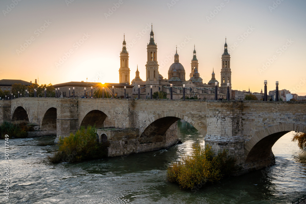 Basilica del Pilar Cathedral with stone bridge crossing Ebro River, Zaragoza, Aragon Basilica del Pilar Cathedral with stone bridge crossing Ebro River, Zaragoza, Aragon